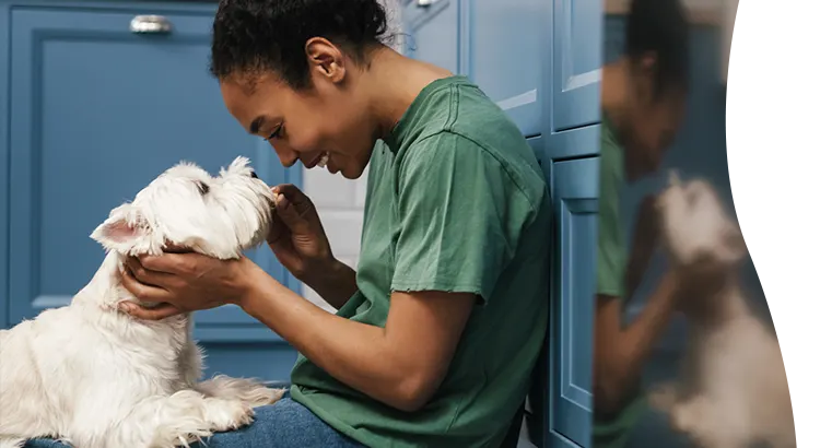A vet tech with a white dog
