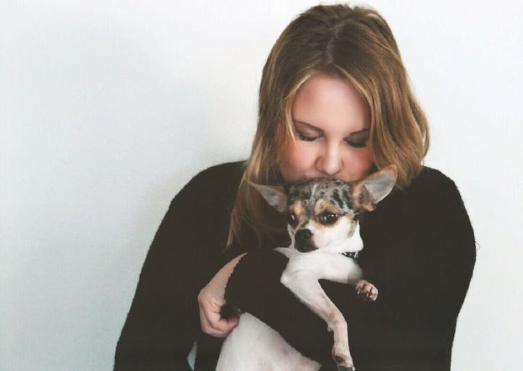 woman-hugs-small-dog