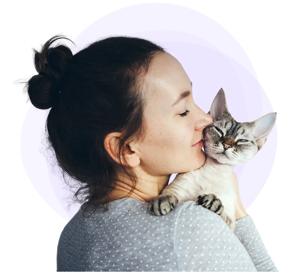 Woman holding a kitten on her shoulder