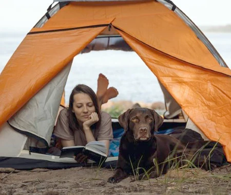 Woman and her dog in a tent